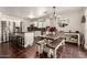 Bright eat-in kitchen with stainless appliances, granite countertops, modern lighting and exposed aggregate flooring at 634 W Aviary Way, Gilbert, AZ 85233
