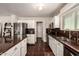 Bright kitchen features stainless steel appliances, granite countertops, white cabinetry, and abundant natural light at 634 W Aviary Way, Gilbert, AZ 85233