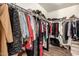 A walk-in closet with shelving and rods for clothing storage at 634 W Aviary Way, Gilbert, AZ 85233