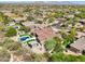 An aerial view shows a home with a pool and outdoor amenities nestled in lush desert landscaping at 7032 E Balancing Rock Rd, Scottsdale, AZ 85266