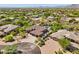 Expansive aerial view of a luxurious home with a pool, lush landscaping, and mountain views at 7032 E Balancing Rock Rd, Scottsdale, AZ 85266
