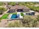 Aerial view of the property showing the backyard pool, outdoor kitchen, and surrounding landscape at 7032 E Balancing Rock Rd, Scottsdale, AZ 85266