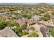Stunning aerial view of a desert home with lush landscaping, surrounded by natural desert vegetation at 7032 E Balancing Rock Rd, Scottsdale, AZ 85266