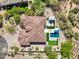 A high angle aerial view of a house with a backyard pool, patio and desert landscaping at 7032 E Balancing Rock Rd, Scottsdale, AZ 85266