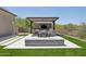 Outdoor living with a dining area, kitchen, and a fireplace that create a cozy entertaining space at 7032 E Balancing Rock Rd, Scottsdale, AZ 85266