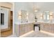 Bathroom with dual vanities, white countertops, wood cabinets, and decorative lighting at 7032 E Balancing Rock Rd, Scottsdale, AZ 85266