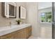 Contemporary bathroom featuring double sinks, illuminated mirrors, and modern finishes at 7032 E Balancing Rock Rd, Scottsdale, AZ 85266
