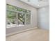 Bedroom with hardwood floors and a large window overlooking lush landscaping at 7032 E Balancing Rock Rd, Scottsdale, AZ 85266