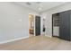 Bright bedroom featuring a light wood floor, closet with sliding doors, and bathroom access at 7032 E Balancing Rock Rd, Scottsdale, AZ 85266