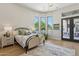 Bedroom with pool view, french doors, ample light, and designer light fixture at 7032 E Balancing Rock Rd, Scottsdale, AZ 85266