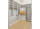 Walk-in closet with custom shelving, wood floors, and ample storage space at 7032 E Balancing Rock Rd, Scottsdale, AZ 85266