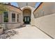 Elegant home entrance with brick pavers, manicured landscaping, and arched entryway at 7032 E Balancing Rock Rd, Scottsdale, AZ 85266