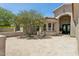 Stunning exterior view featuring brick driveway, elegant arched entryway, and mature landscaping for added curb appeal at 7032 E Balancing Rock Rd, Scottsdale, AZ 85266