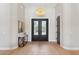 Elegant foyer features hardwood floors, a modern light fixture, and double front doors, creating a welcoming entrance at 7032 E Balancing Rock Rd, Scottsdale, AZ 85266