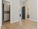 Hallway with views to closet, living room, and bathroom with neutral colors and hardwood floors at 7032 E Balancing Rock Rd, Scottsdale, AZ 85266