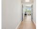 Hallway features wood floors and decorative doors leading to a seating area with large windows at 7032 E Balancing Rock Rd, Scottsdale, AZ 85266
