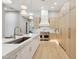 Modern kitchen featuring a large island with a sink, custom cabinets, and stainless steel appliances perfect for cooking at 7032 E Balancing Rock Rd, Scottsdale, AZ 85266