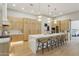 Modern kitchen with a large waterfall island, stainless steel appliances, and custom cabinetry at 7032 E Balancing Rock Rd, Scottsdale, AZ 85266
