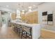 Spacious kitchen features a waterfall island, wood cabinets, designer lighting, and hardwood floors at 7032 E Balancing Rock Rd, Scottsdale, AZ 85266