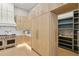 The gourmet kitchen features custom cabinets, countertops, and high-end stainless steel appliances at 7032 E Balancing Rock Rd, Scottsdale, AZ 85266