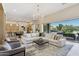 Bright living room featuring hardwood floors, modern lighting, and a large sectional sofa at 7032 E Balancing Rock Rd, Scottsdale, AZ 85266