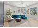 Comfortable living room with a modern teal sectional sofa and neutral decor at 7032 E Balancing Rock Rd, Scottsdale, AZ 85266