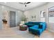 Stylish living room featuring hardwood floors and a modern teal sectional sofa at 7032 E Balancing Rock Rd, Scottsdale, AZ 85266