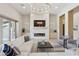 Spacious living room features a stone fireplace, modern lighting, and comfortable seating perfect for relaxation and entertainment at 7032 E Balancing Rock Rd, Scottsdale, AZ 85266