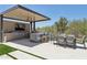 Outdoor kitchen and dining area with modern appliances, seating, and a covered patio at 7032 E Balancing Rock Rd, Scottsdale, AZ 85266