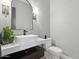 Elegant powder room featuring a modern vanity, stylish mirror, and neutral wallpaper at 7032 E Balancing Rock Rd, Scottsdale, AZ 85266
