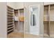 Spacious walk-in closet boasts custom shelving, rods, and a stylish design at 7032 E Balancing Rock Rd, Scottsdale, AZ 85266