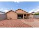 Private backyard with brick patio, desert landscaping, and covered patio area at 7333 N 69Th Ave, Glendale, AZ 85303
