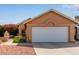 Charming home featuring a large two-car garage and desert landscaping, showcasing curb appeal at 7333 N 69Th Ave, Glendale, AZ 85303