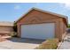 Home exterior showcasing a two-car garage, clean lines, and desert landscaping, inviting and well-maintained at 7333 N 69Th Ave, Glendale, AZ 85303