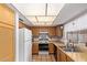 Functional kitchen with wood cabinets, a white refrigerator, and ample counter space, perfect for cooking at 7333 N 69Th Ave, Glendale, AZ 85303