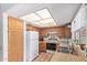 Charming kitchen with wood cabinets, white appliances, and tile flooring at 7333 N 69Th Ave, Glendale, AZ 85303