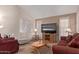 Spacious living room with carpet, complemented by ample seating and natural light at 7333 N 69Th Ave, Glendale, AZ 85303