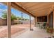 Relaxing covered patio with charming seating area and serene backyard views at 7333 N 69Th Ave, Glendale, AZ 85303