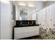 Modern bathroom with double vanity, sleek fixtures, and a shower with a decorative curtain at 7857 N 21St Ave, Phoenix, AZ 85021
