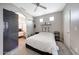 Bright bedroom featuring a cozy bed, ceiling fan, and adjacent bathroom at 7857 N 21St Ave, Phoenix, AZ 85021