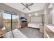 Bright bedroom featuring a bed, ceiling fan, and large window with scenic views at 7857 N 21St Ave, Phoenix, AZ 85021