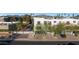 Contemporary townhouse with white exterior, mature landscaping, and garages below, offering modern living and convenience at 7857 N 21St Ave, Phoenix, AZ 85021