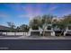 Street view of modern townhomes featuring private garages, small balconies, and a contemporary design at 7857 N 21St Ave, Phoenix, AZ 85021