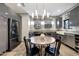 Modern eat-in kitchen with gray cabinets, stainless appliances, and bright pendant lighting at 7857 N 21St Ave, Phoenix, AZ 85021