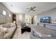Inviting living room featuring neutral tones, plush seating, a ceiling fan, and seamless flow to the kitchen at 7857 N 21St Ave, Phoenix, AZ 85021
