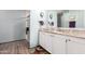 Well-lit bathroom with a white vanity, granite countertops, and a glass-enclosed shower at 8209 E 5Th Ave, Mesa, AZ 85208