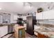 Modern kitchen featuring stainless steel appliances, white cabinets, and granite countertops at 8209 E 5Th Ave, Mesa, AZ 85208