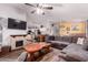 The living room showcases an open floor plan with a stone fireplace, wooden table and dark flooring at 8209 E 5Th Ave, Mesa, AZ 85208