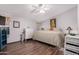 Cozy main bedroom with natural lighting, a ceiling fan, laminate flooring, and neutral décor at 8209 E 5Th Ave, Mesa, AZ 85208