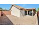 Home's backyard features desert landscaping and a covered patio at 825 E Michigan Ave, Phoenix, AZ 85022